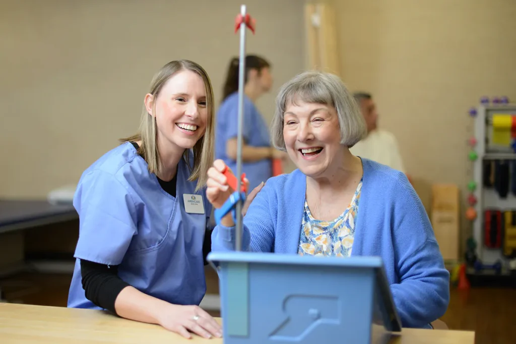 patient doing physical therapy exercise while caregiver assists